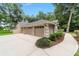 Attached two-car garage with clean design, surrounded by manicured landscaping and a well-maintained driveway at 733 Se 67Th Ln, Ocala, FL 34480