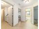 Hallway featuring tile flooring, multiple doorways, and a built-in storage cabinet at 733 Se 67Th Ln, Ocala, FL 34480