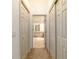 Hallway with neutral colored carpet leading to bathroom area with tile flooring at 733 Se 67Th Ln, Ocala, FL 34480