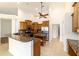Open kitchen featuring wooden cabinets, granite countertops, stainless steel appliances, and large island at 733 Se 67Th Ln, Ocala, FL 34480