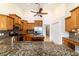Spacious kitchen with wooden cabinets, granite countertops, and stainless steel appliances at 733 Se 67Th Ln, Ocala, FL 34480