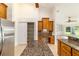 Bright kitchen boasts a pantry, wooden cabinets, granite countertops, and tiled backsplash at 733 Se 67Th Ln, Ocala, FL 34480
