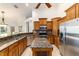 Kitchen featuring wooden cabinets, granite countertops, island, and stainless steel appliances at 733 Se 67Th Ln, Ocala, FL 34480