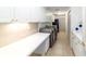 Functional laundry room with white cabinets, countertop space, and modern washer and dryer at 733 Se 67Th Ln, Ocala, FL 34480