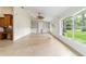 Spacious living room with tiled floor, vaulted ceiling, and large windows offering a view of the outdoors at 733 Se 67Th Ln, Ocala, FL 34480
