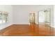 Hardwood living area with natural lighting and open access to other rooms at 733 Se 67Th Ln, Ocala, FL 34480