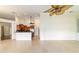 Open-concept living area with tiled floor, kitchen bar, and ceiling fans providing a comfortable atmosphere at 733 Se 67Th Ln, Ocala, FL 34480