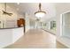 Bright living room with tiled floor, built-in shelving, and large windows with views of the landscaped yard at 733 Se 67Th Ln, Ocala, FL 34480