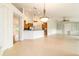 Open-concept living space with tiled floors, kitchen bar, bright windows, and built-in shelving at 733 Se 67Th Ln, Ocala, FL 34480