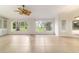 Inviting living room featuring windows looking out on the backyard, and light neutral colored tile floors at 733 Se 67Th Ln, Ocala, FL 34480
