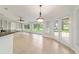 Bright living room with tile floors, built-in shelves, and access to the outdoors at 733 Se 67Th Ln, Ocala, FL 34480