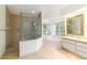 Tiled bathroom featuring a tiled shower, soaking tub, and vanity area at 733 Se 67Th Ln, Ocala, FL 34480