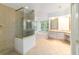 Spacious main bathroom with tiled shower, soaking tub, and vanity at 733 Se 67Th Ln, Ocala, FL 34480
