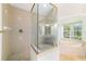The main bathroom features a glass shower and soaking tub with tub filler at 733 Se 67Th Ln, Ocala, FL 34480