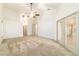 Main bedroom featuring a ceiling fan, neutral carpeting, and glass patio doors at 733 Se 67Th Ln, Ocala, FL 34480
