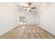 Bright main bedroom featuring neutral carpeting, ceiling fan, and outdoor access at 733 Se 67Th Ln, Ocala, FL 34480