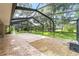 Large screened patio with brick pavers and decorative stone, perfect for outdoor living and entertaining at 733 Se 67Th Ln, Ocala, FL 34480