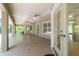 Bright screened patio featuring a wide open floor plan, a neutral paint scheme, with tiled floors and backyard access doors at 733 Se 67Th Ln, Ocala, FL 34480