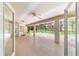 Long screened patio featuring a wide open floor plan, neutral paint, tiled floors, and view of back yard at 733 Se 67Th Ln, Ocala, FL 34480