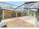 Expansive screened patio featuring brick and gravel accents, offering ample space for outdoor relaxation and entertainment at 733 Se 67Th Ln, Ocala, FL 34480