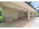 Covered screened patio with neutral paint and brick accents, a ceiling fan, and direct access to backyard views at 733 Se 67Th Ln, Ocala, FL 34480