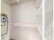 Well-organized utility closet featuring efficient shelving and an on-demand hot water heater system at 733 Se 67Th Ln, Ocala, FL 34480