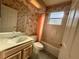 Bathroom featuring a vanity with a floral wallpaper and a shower-tub combo at 7421 Sw 110Th Pl, Ocala, FL 34476