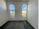 Empty bedroom featuring natural light from arched windows with carpeting at 7421 Sw 110Th Pl, Ocala, FL 34476