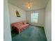 Bedroom features a futon, ceiling fan, and natural light from a window at 7421 Sw 110Th Pl, Ocala, FL 34476