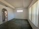 Generously sized bedroom with tray ceiling, a view into bathroom, and natural light from a window at 7421 Sw 110Th Pl, Ocala, FL 34476