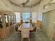 Formal dining room with travertine table, six chairs, china cabinet, and decorative ceiling border at 7421 Sw 110Th Pl, Ocala, FL 34476