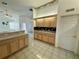 An expansive kitchen with a breakfast bar, ample cabinet space, and views into adjacent rooms at 7421 Sw 110Th Pl, Ocala, FL 34476