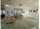 Spacious living room featuring high ceilings, bright windows, and comfortable seating arrangement at 7421 Sw 110Th Pl, Ocala, FL 34476