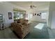 Spacious living room featuring high ceilings, bright windows, and comfortable seating arrangement at 7421 Sw 110Th Pl, Ocala, FL 34476