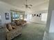 Spacious living room featuring high ceilings, bright windows, and comfortable seating arrangement at 7421 Sw 110Th Pl, Ocala, FL 34476