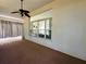 Covered patio featuring neutral walls, ceiling fan, and view to the home's interior at 7421 Sw 110Th Pl, Ocala, FL 34476
