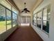 Enclosed sunroom features multiple windows with a ceiling fan and outdoor views at 7421 Sw 110Th Pl, Ocala, FL 34476