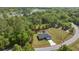 Aerial view of the property, showcasing its location, lot size and proximity to wooded areas at 77 Locust Dr, Ocala, FL 34472