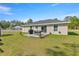 A pleasant backyard featuring a patio with outdoor furniture, ideal for relaxing and entertaining at 77 Locust Dr, Ocala, FL 34472