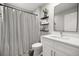 Cozy bathroom featuring a sink and toilet next to a striped shower curtain at 77 Locust Dr, Ocala, FL 34472