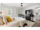 Bright bedroom showcasing a bed with decorative pillows, a crib, and an entertainment center at 77 Locust Dr, Ocala, FL 34472