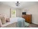 Bedroom with a full dresser and TV setup, as well as cozy decor at 77 Locust Dr, Ocala, FL 34472