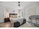 Cozy bedroom with a dark bedframe, neutral decor, and a crib, creating a tranquil atmosphere at 77 Locust Dr, Ocala, FL 34472