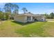 Beautiful one-story home featuring a lush front lawn and a two car garage at 77 Locust Dr, Ocala, FL 34472