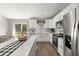 Modern kitchen featuring an island with seating, white cabinetry, and stainless steel appliances at 77 Locust Dr, Ocala, FL 34472