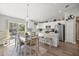 Modern kitchen with white cabinetry, an island with seating, and stainless steel appliances at 77 Locust Dr, Ocala, FL 34472