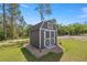 Well-maintained backyard storage shed with double doors and ample space for outdoor equipment at 77 Locust Dr, Ocala, FL 34472