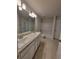 Spacious bathroom with dual sinks, granite countertops, modern lighting, and a tub-shower combo at 8344 Sw 57Th Ct, Ocala, FL 34476