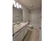 Bathroom vanity with stone countertop, modern lighting, and a shower-tub combination at 8344 Sw 57Th Ct, Ocala, FL 34476