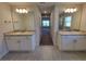 Bathroom features dual vanities with granite countertops and a well-lit, modern design at 8344 Sw 57Th Ct, Ocala, FL 34476